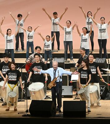 地元合唱団の子どもたちと共演する渡辺貞夫さん（最前列中央）＝19日午後、宇都宮市文化会館大ホール