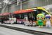 １日から運行開始するラッピング列車の前で記念撮影する選手ら