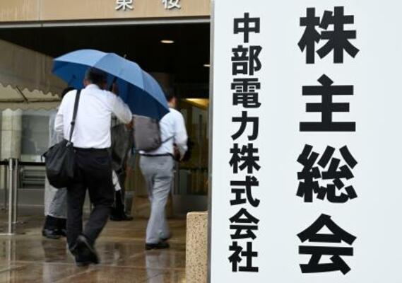 　中部電力の定時株主総会の会場へ向かう人たち＝２５日午前、名古屋市