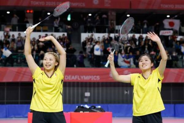 　女子ダブルスで優勝し、観客に笑顔で手を振る矢ケ部紋可（右）と真衣＝武蔵野の森総合スポーツプラザ