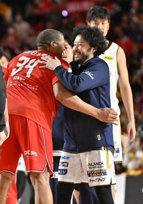 試合後、笑顔で抱擁する千葉Ｊのギブス（左）とブレックスの田臥＝千葉県船橋市のららアリーナ東京ベイ