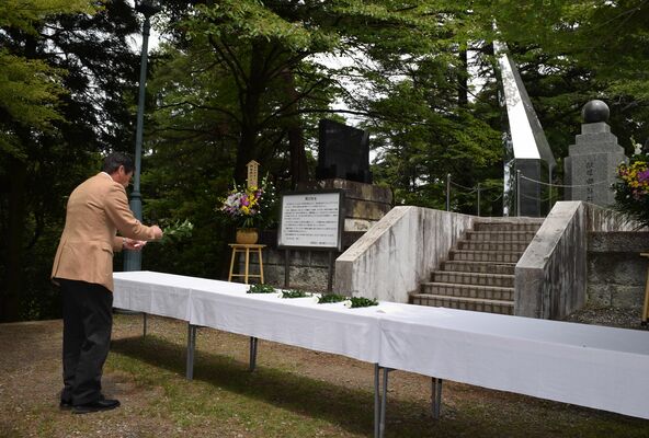 献眼者をしのび花を手向ける参列者＝28日午前、宇都宮市塙田５丁目