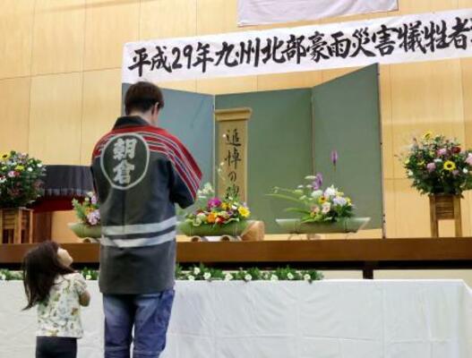 2017年の九州北部の豪雨から9年となり、被害が大きかった福岡県朝倉市松末地区に設置された献花台に花を手向ける住民=5日午前