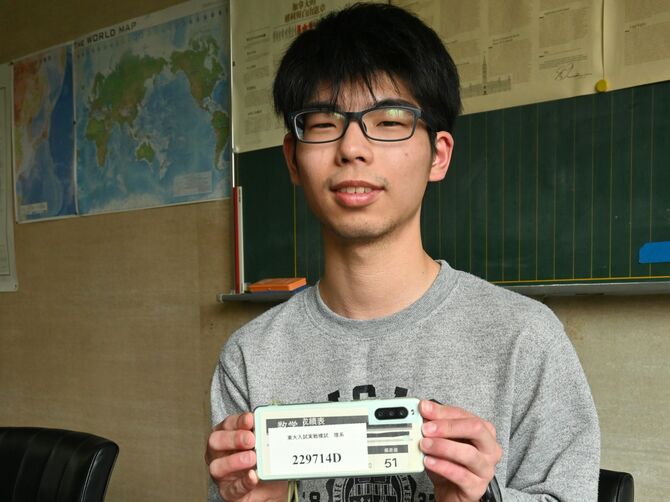 東大に現役合格した坂巻さん。「戒め」として結果の良くなかった数学の成績表をスマホに挟んでいた＝3月撮影