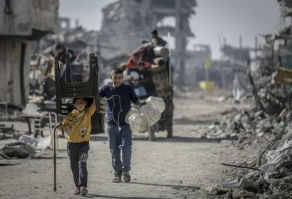 ガザ地区を歩くパレスチナ人の家族=21日(ゲッティ=共同)