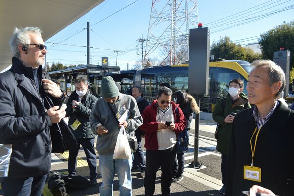 担当者（右端）からＬＲＴの停留場の特徴などを聞く研修員たち＝18日正午、宇都宮市清原工業団地