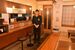 カウンターと小上がりのある店内に立つ板垣代表