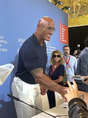 　記者会見後にファンと握手するドウェイン・ジョンソン＝イタリア・ベネチア（共同）