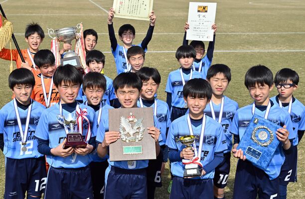 優勝盾などを手にし喜ぶリフレＳＣ（宇河）＝23日午後、真岡市総合運動公園陸上競技場
