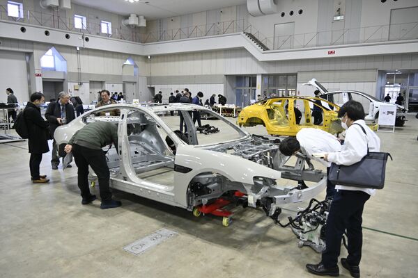 海外メーカーのＥＶが完成車や分解部品の状態で並んだ展示見学会＝４日午前、宇都宮市