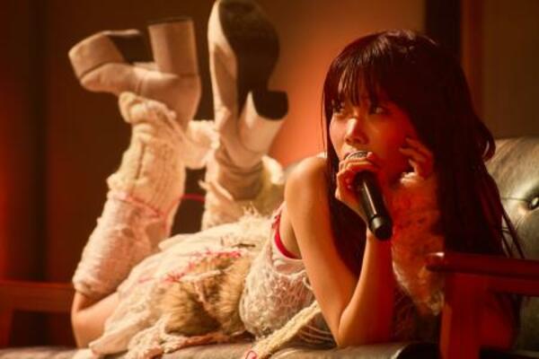 ステージに置いたソファに寝そべりパフォーマンスするアイナ・ジ・エンド