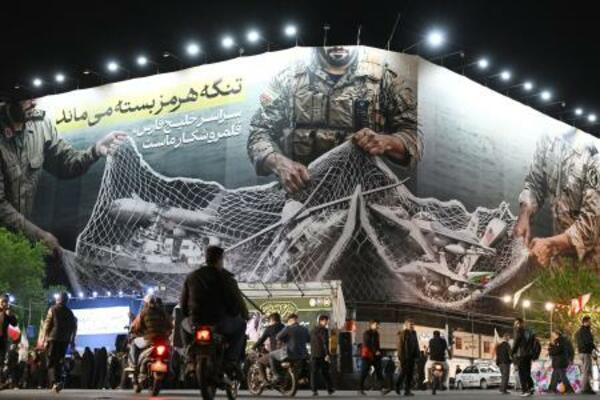 　イランの首都テヘランに掲げられた、ホルムズ海峡掌握による米イスラエルへの徹底抗戦を訴える看板＝２１日（共同）