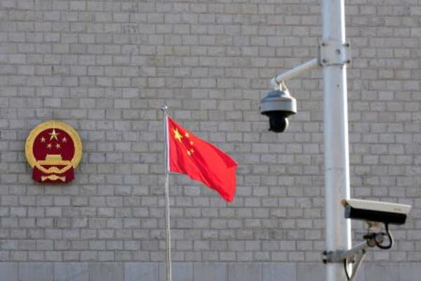 董郁玉氏の公判が開かれた北京市の高級人民法院前に掲げられた中国国旗と監視カメラ=13日(共同)