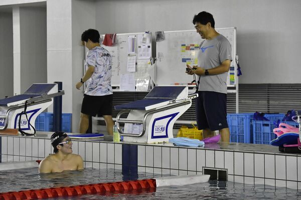 競泳の世界選手権を前に、東洋大の平井伯昌監督(右)と練習する松下=東洋大総合スポーツセンタープール、内藤大地撮影