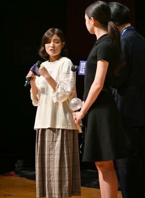 映画「トロフィー」の出演者と舞台あいさつする孫明雅監督(左)=5日、韓国京畿道富川市(共同)