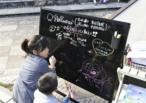 ボードに街なかの好きなところを書き込む子どもたち