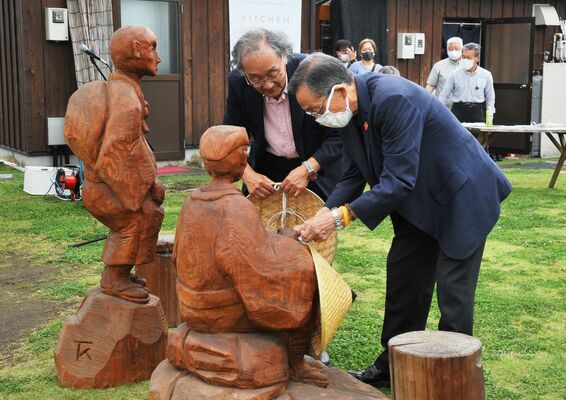 芭蕉像のかさを交換する佐藤市長（右）と樽見会長