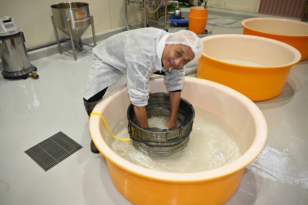 極寒の中、素手で７キログラムの掛け米を洗米する筆者＝１月７日、鹿沼市上粕尾