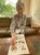 疎開した友人らと写った写真で、当時の自身を指さす飯沼さん＝７月、下野市小金井