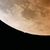青白い光を放ち、皆既食中の月に潜入し始める天王星＝８日午後８時41分