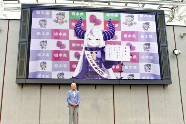 とちぎ未来大使の委嘱状を受け取ったラプラスさん（上）と福田知事＝３日午後、宇都宮市江野町