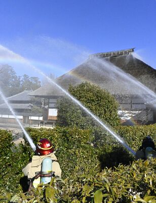 史跡足利学校の「方丈」前で放水する消防署員ら