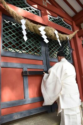 登拝門にかんぬきをかける斎藤権宮司