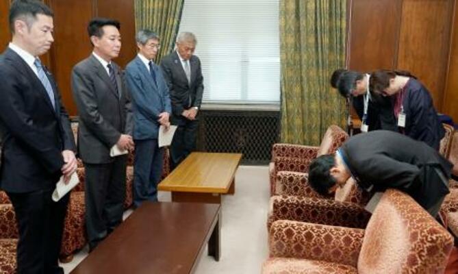 日本維新の会の前原前共同代表(左手前から2人目)らに謝罪する国交省の五十嵐徹人鉄道局長(右手前)=14日午後、国会
