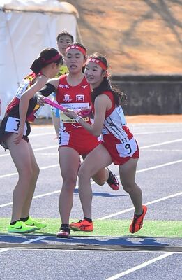 女子真岡の２区・山口彩（左）から３区吉川にたすきが渡る＝滋賀県野洲市希望が丘文化公園