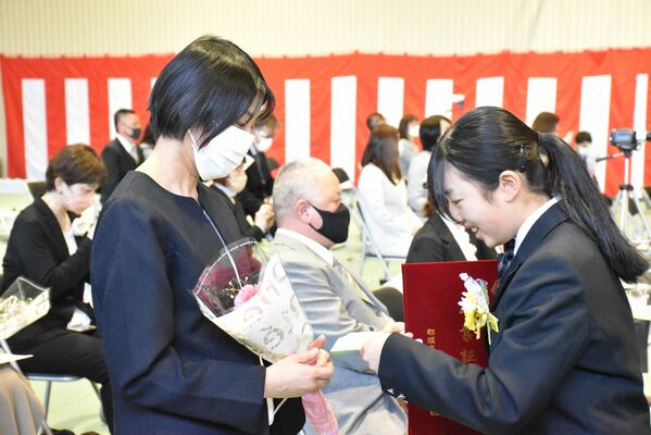 保護者に花束と手紙を贈る３年生