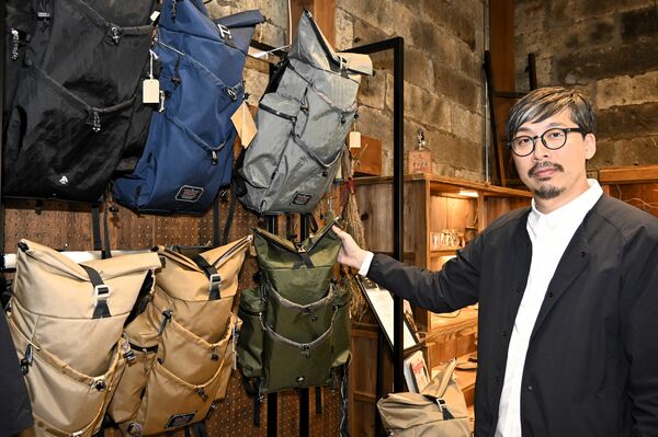個性的なバックパックについて説明する井上代表