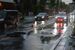 大雨の影響でマンホールがずれたままの道路。警察官が交通整理に当たった＝11日午後６時55分、宇都宮市昭和１丁目（画像は一部を修正しています）