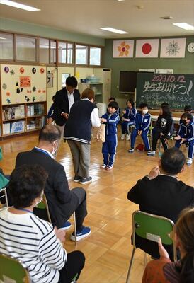 教職員にお菓子を渡しながら感謝を述べる児童ら