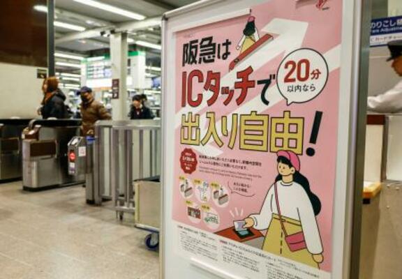 　交通系ＩＣカードを使って入場券なしで改札内に滞在できるサービスが始まったことを伝えるポスター＝１９日、阪急大阪梅田駅