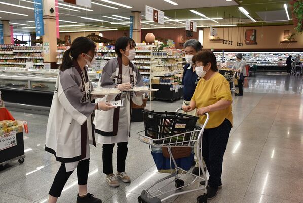 買い物客に「ゆうだい21」をＰＲする宇大の学生ら＝17日午前、宇都宮市五代１丁目