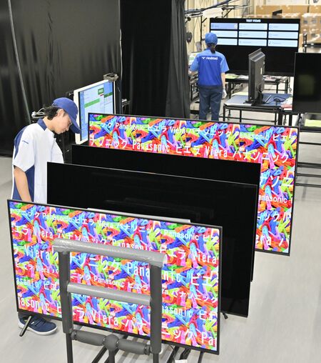 テレビの修理後には電源を入れて動作を確認する=16日午前、宇都宮市平出工業団地