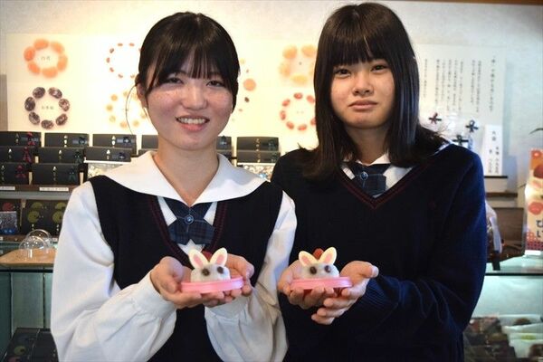 すずらん本舗と共同開発したイチゴ大福を手にする柳さん（左）、増田さん