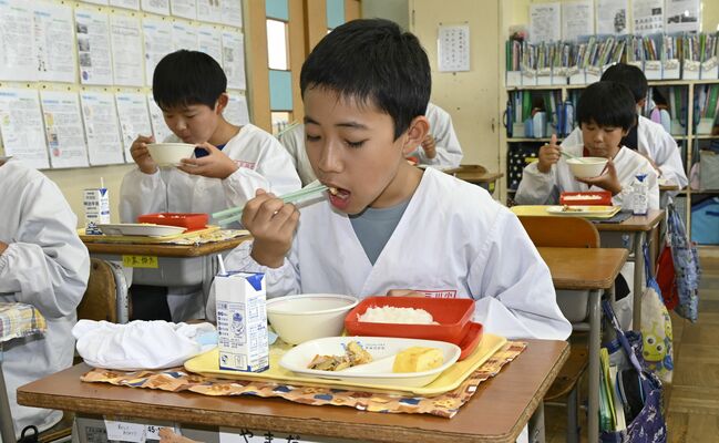 みそ汁に入ったふくべを頬ばる児童