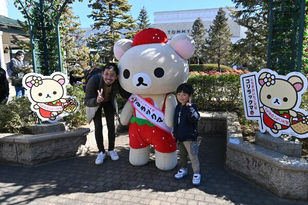コリラックマとの写真撮影を楽しむ親子