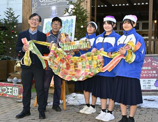 鈴木社長（左）に消防ホースを再利用したハンモックなどを寄贈した黒磯北中の生徒ら