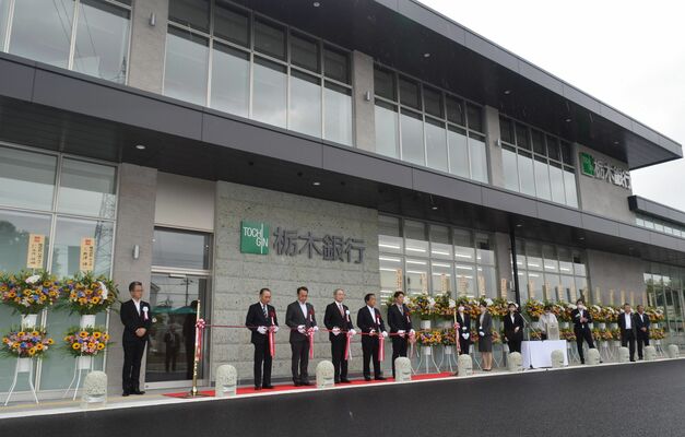 氏家支店オープンでテープカットに臨んだ関係者ら＝27日午前、さくら市