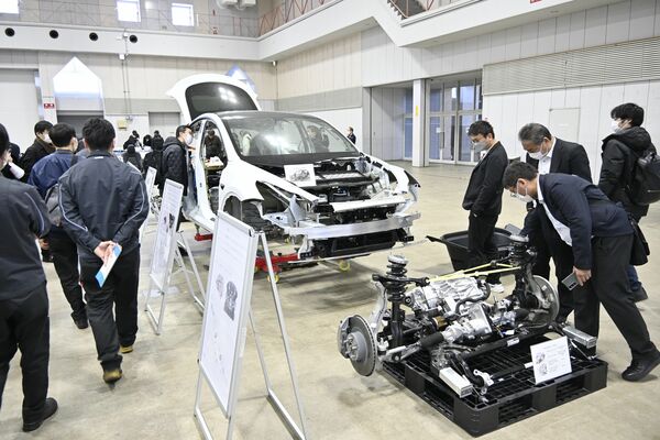 海外メーカーのＥＶが完成車や分解部品の状態で並んだ展示見学会＝４日午前、宇都宮市