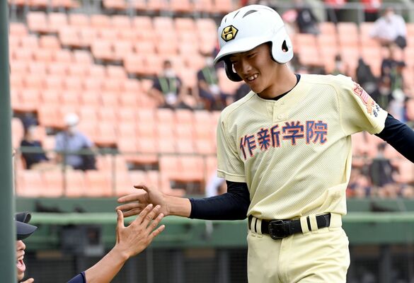高校野球軟式の部準決勝　３回、先制のホームを踏み、ベンチで仲間に迎えられる作新の大沼