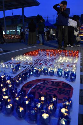 キャンドルのオブジェを写真に収める来場者