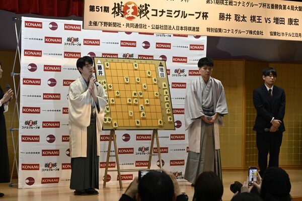 本県ファンらの前で対局を振り返る藤井棋王(左)=15日午後7時半、日光市鬼怒川温泉大原