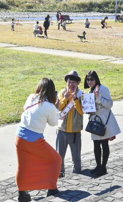 一日駅長として記念写真の要望に応えるヒデさん（中央）