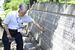 広島県立第二中（当時）の慰霊碑に刻まれた下級生たちの名前をなぞる山本さん＝７月30日午後、広島市