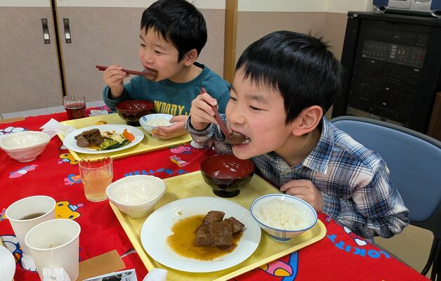 サイコロステーキを頬張る子どもたち