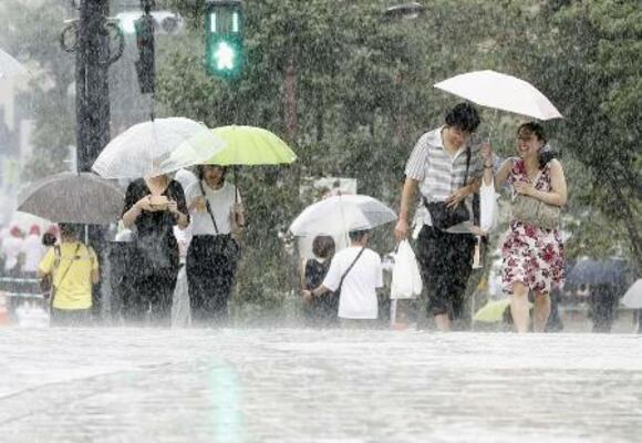 　台風が接近し土砂降りの雨の中を歩く人たち＝２０１９年９月、東京都品川区