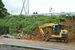 擁壁ブロックや土砂が崩れた国道１２３号。重機で撤去作業が行われた＝４日午後３時35分、茂木町北高